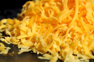 Preventing moisture and clumping in pre-shredded cheese when purchased in bulk